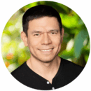 headshot of person in front of a blurred green background