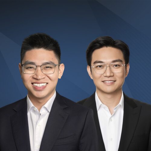 Long Pham EruBase Headshot of two people wearing glasses and business attire, smiling in front of a blue background.